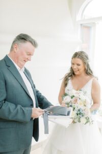 Bride and father of bride opening gift day of wedding.